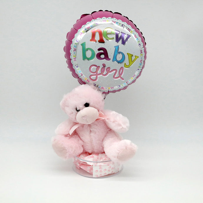 Balloon, teddy bear, and dish of candy